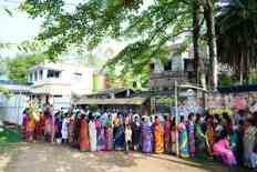 Woman Ties Rakhi To PM Modi As Huge Crowd Gathers Outside Polling Both In...
